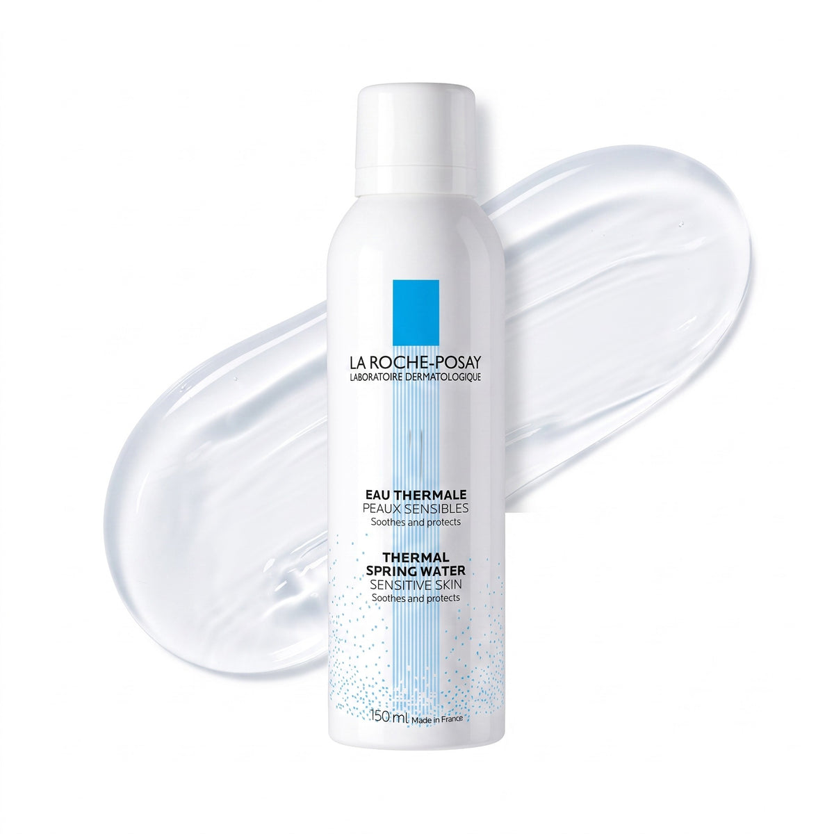 A 150 mL white bottle of La Roche-Posay Thermal Spring Water Sensitive Skin, shown in front of a translucent, glossy swipe of the product on a clean white background.